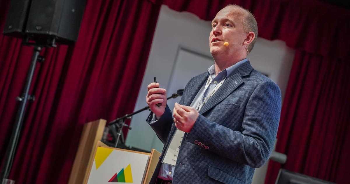 Change Conference speaker speaking and looking at an audience
